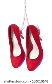 Red Womens Shoes On Hairpins Hang On The Coat Hanger On A White Background