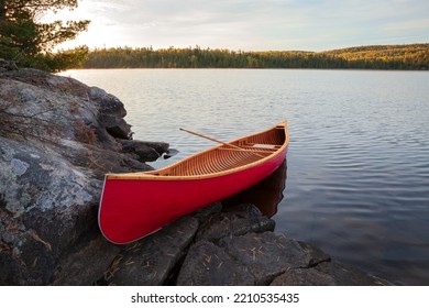 Red Wood Canoe On Rocky Island In The Boundary Waters On A Bright Fall Morning