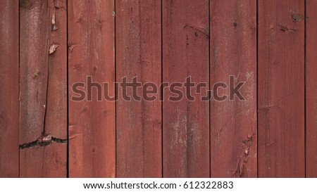 Red wood wall,  aged and worn out, painted with a traditional red soil paint.