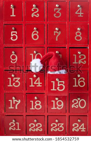 Red wooden Advent calendar with surprise for Christmas