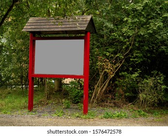 Red Wooden Billboard In A Park, Mock Up. Graphic Resource. Nobody.