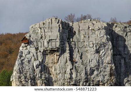  Red wooden climber house in the Lakatnik rocks and Alpine climber, Iskar river defile, Sofia province, Bulgaria  