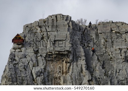  Red wooden climber house in the Lakatnik rocks and Alpine climber, Iskar river defile, Sofia province, Bulgaria 