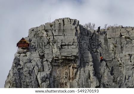  Red wooden climber house in the Lakatnik rocks and Alpine climber, Iskar river defile, Sofia province, Bulgaria 