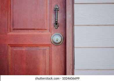 Red wooden  door and round metal door lock with handle grip - Powered by Shutterstock