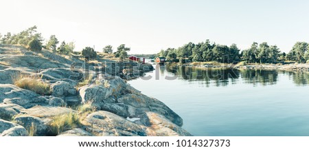 Red wooden house in lake landscape in Sweden, forest, panorama in summer, Norrmalm, Sundsvall, Gothenburg, Gotland