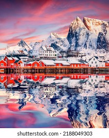 Red wooden houses reflected in calm waters of Gravdal bay. Great minter scene of popular tourist destination - Lofoten Islands. Beautiful seascape of Norwegian sea, Sakrisoy village, Norway, Europe. - Shutterstock ID 2188049303
