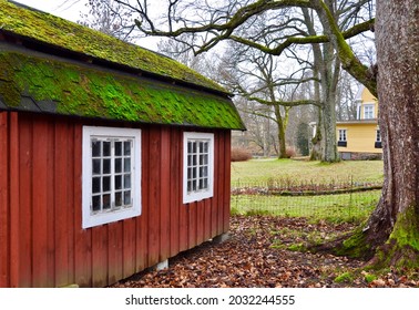 Red Wooden Playhouse In The Garden