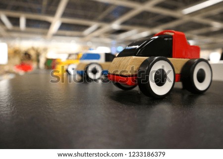 Red wooden toy car.                             