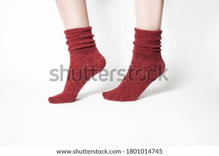 Red wool female socks on her feets