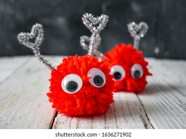 
Red Wool Pompon Doll On Wooden