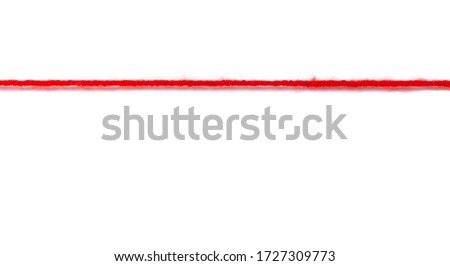 Red woolen thread stretched on a white background