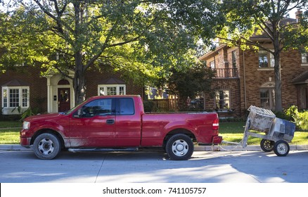 Red Work Pick Up Truck Pulling Small Cement Mixer Parked On Street In Traditional Neighborhood