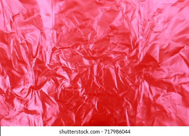 Red Wrinkled Plastic Texture Background.