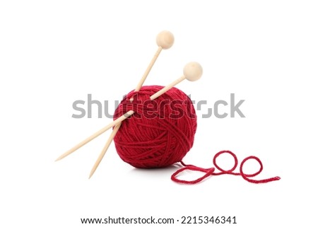 Red yarn ball with knitting needles, isolated on white background.