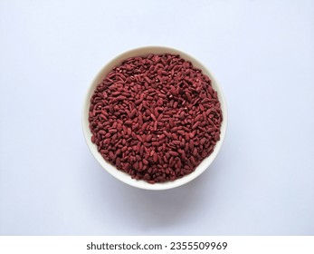 Red Yeast Rice on A Ceramic Bowl Isolated in the White Background