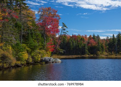 Red And Yellow Autumn Colors Are Reflected In Adams Reservoir, Along The Molly Stark Trail, Near Woodford Vermont.