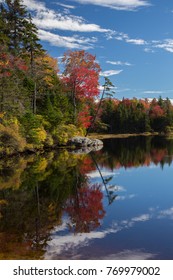 Red And Yellow Autumn Colors Are Reflected In Adams Reservoir, Along The Molly Stark Trail, Near Woodford Vermont.