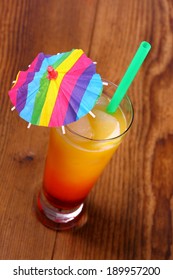 Red, Yellow Cocktail With Lemon, Straw, Umbrella Deco, Top View