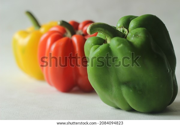 Red yellow and green bell peppers. Bell pepper or\
Capsicum annuum, also called sweet pepper or capsicum. Bell peppers\
are used in salads and in cooked dishes and are high in vitamin A\
and vitamin C