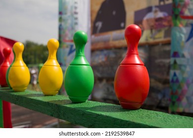 Red , Yellow  And Green Colored Plastic Skittles Stand In Row