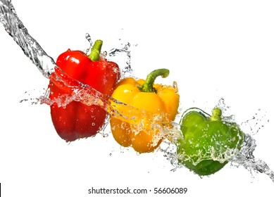 red, yellow and green pepper with water splash isolated on white
