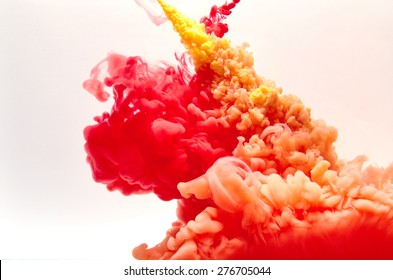 Red and yellow inks making clouds in water - Powered by Shutterstock