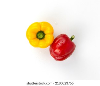 Red and yellow natural bell peppers isolated on white background. Healthy foods concept of meal, diet, fruits, chilis, yellow and red