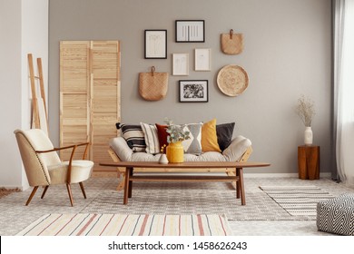 Red, Yellow And Patterned Pillows On Elegant Scandinavian Living Room Sofa