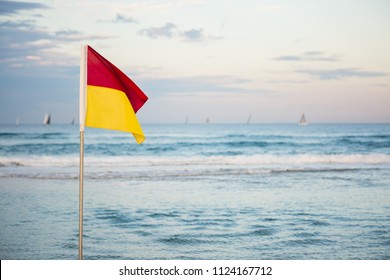 Red And Yellow Saftey Flag On Australian Beach On The Gold Coast