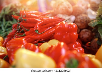 Red And Yellow Sweet Paprika Peppers On Bazaar Counter In Egypt With Sunlight. Farm Products Concept.