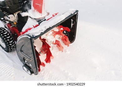 Red-black snowblower machine in the process of work. High quality photo