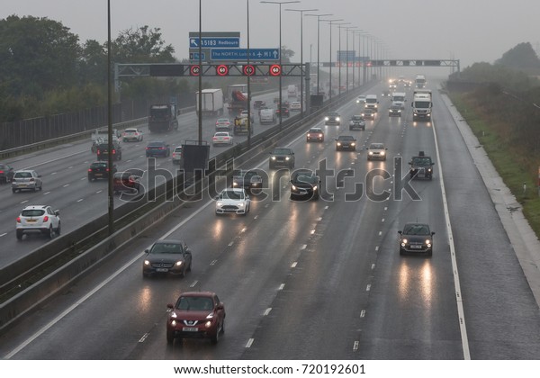 REDBOURN, UK - SEPTEMBER 21, 2017:\
Traffic on busy British motorway M1 in a bad rainy\
weather.
