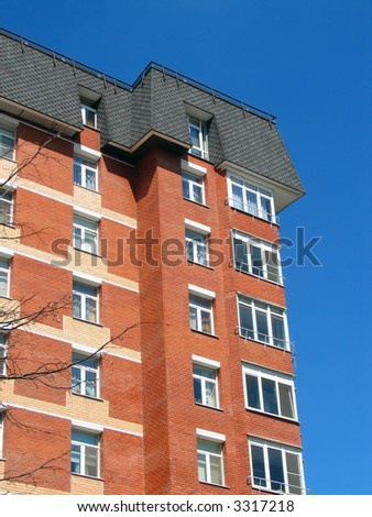 red-brick building offset against a deep blue sky
