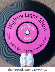 Redcliffe, Queensland / Australia 08 21 2018: A pair of white shoes standing on a disco sticker 