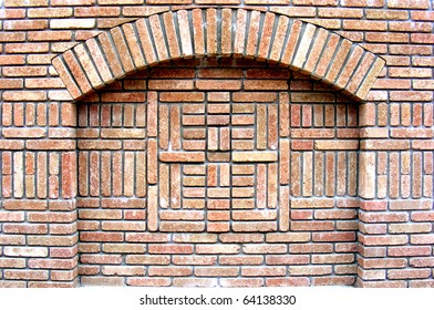 Reddish brick wall with arch.