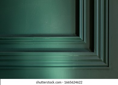 Redecoration of apartment, Finishing Works - Fragment Of Classic Green Walls With Installed Wall Panels, Decorated With Moldings. Сorner of the frame baguette