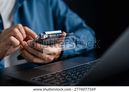 Redeem code and discount voucher concept. Person using smartphone to enter code with gift box.
