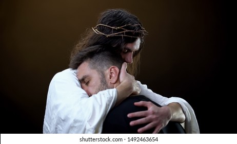 Redeemer hugging unhappy man, faith in God, spiritual protection, eternity