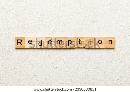 redemption word written on wood block. redemption text on cement table for your desing, concept.