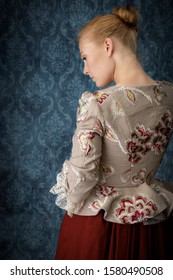 Red-haired 18th Century Woman Wearing An Embroidered Bodice