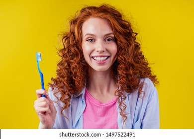 Redhaired Ginger Woman Brushing Teeth With Toothpaste Eco Paste On Yellow Studio Background.