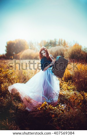 Red-haired girl in the field. Portrait
