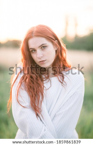 Similar – Young redhead woman surrounded by plants