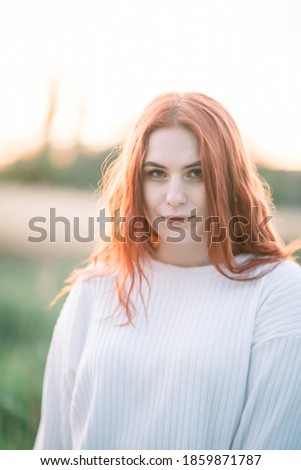 Similar – Young redhead woman surrounded by plants