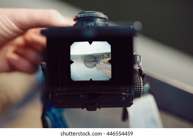 The red-haired guy holding a medium format film camera in his hands