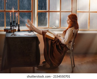 red-haired medieval woman sits on chair, legs lie on table, brutal pose. Girl fashion model in vintage elegant dress reading historical detective book. Romantic lady countess in night library old room - Shutterstock ID 2154550701