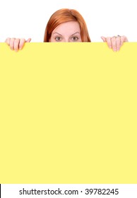 A Red-haired Woman Peeks Over The Top Of A Yellow Wall, With Only Her Fingers And The Top Half Of Her Head Visible. Vertical Format.