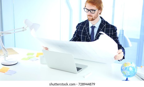 Redhead Architectural Engineer Working on Blueprint, Freelancer Desginer