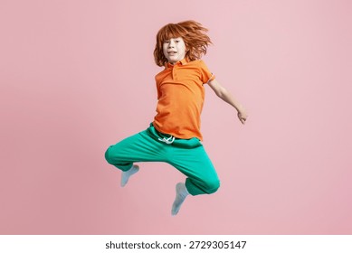 Redhead boy jumping with lively expression, personifying childhood, energy, and dynamic movement